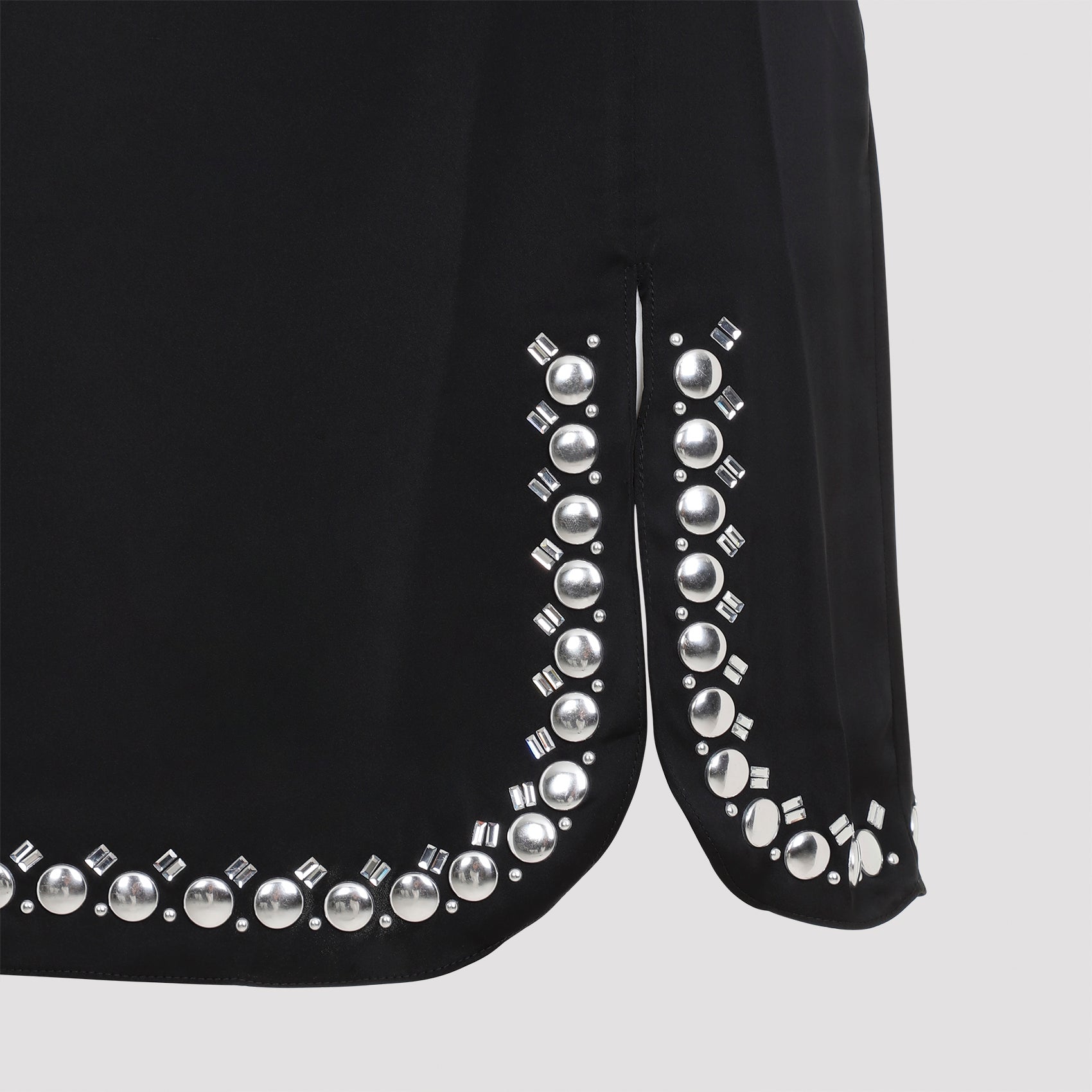 Black Rabanne mini skirt showing side slits and asymmetric hem detail