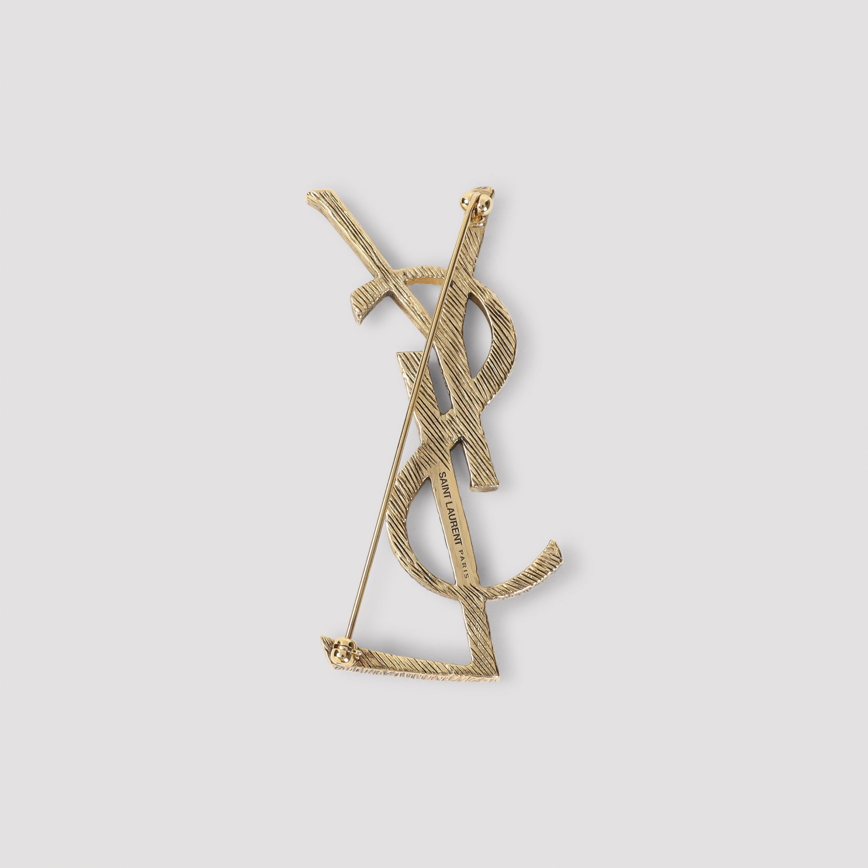 Saint Laurent golden brooch reverse side with pin fastening