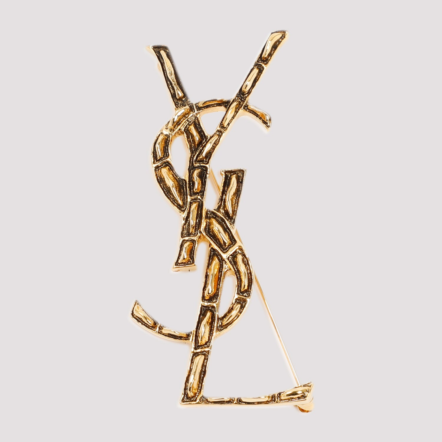 Gold-toned YSL monogram brooch, angled view by Saint Laurent