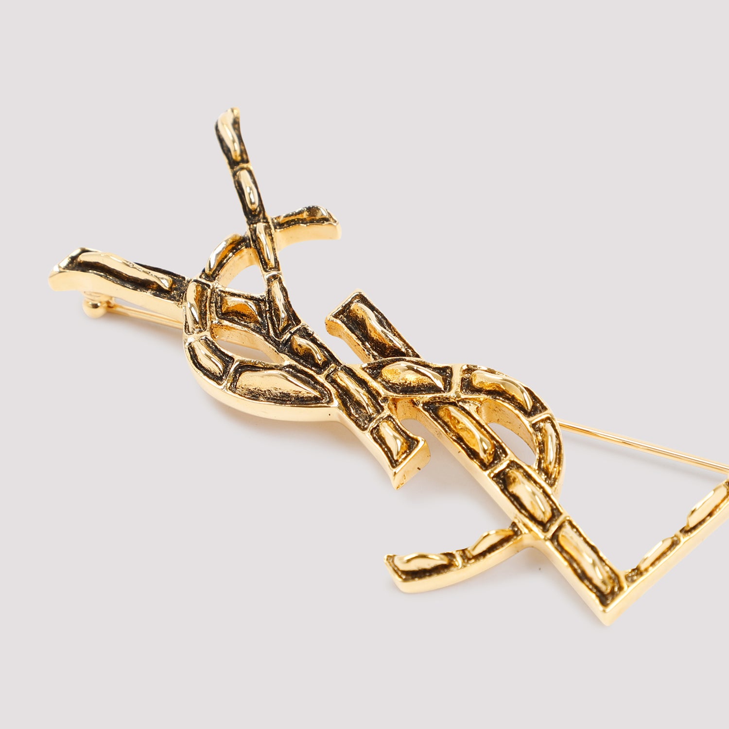 Gold brass brooch with YSL emblem, side profile by Saint Laurent