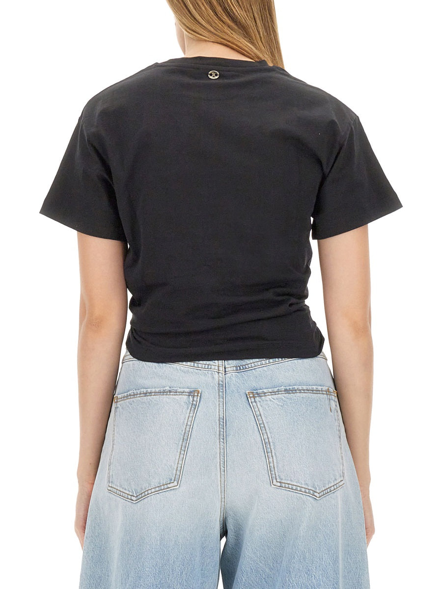 Paco Rabanne black crop top with curved hem, close-up view