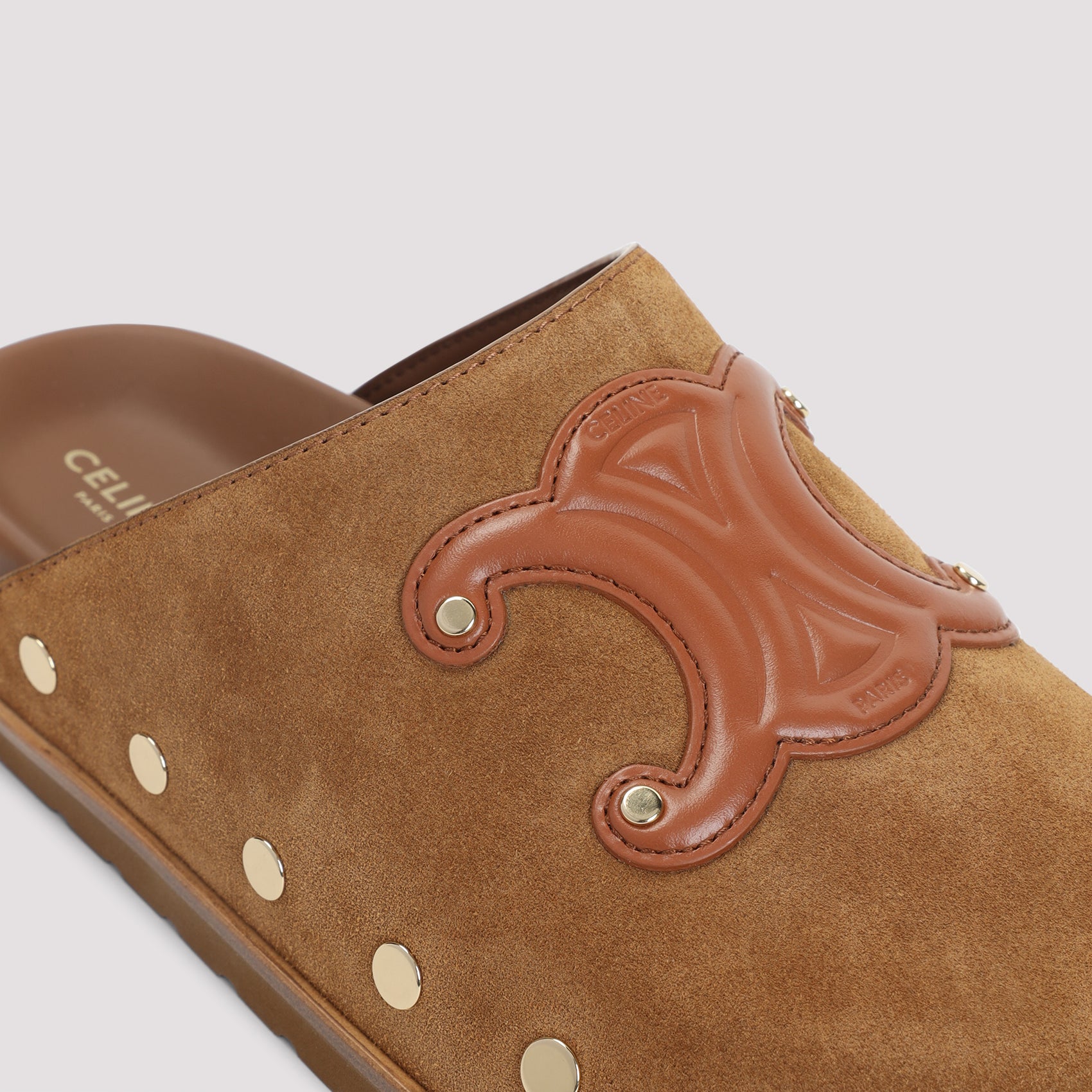 Brown suede Celine Triomphe wedge mules showing leather insole, interior view