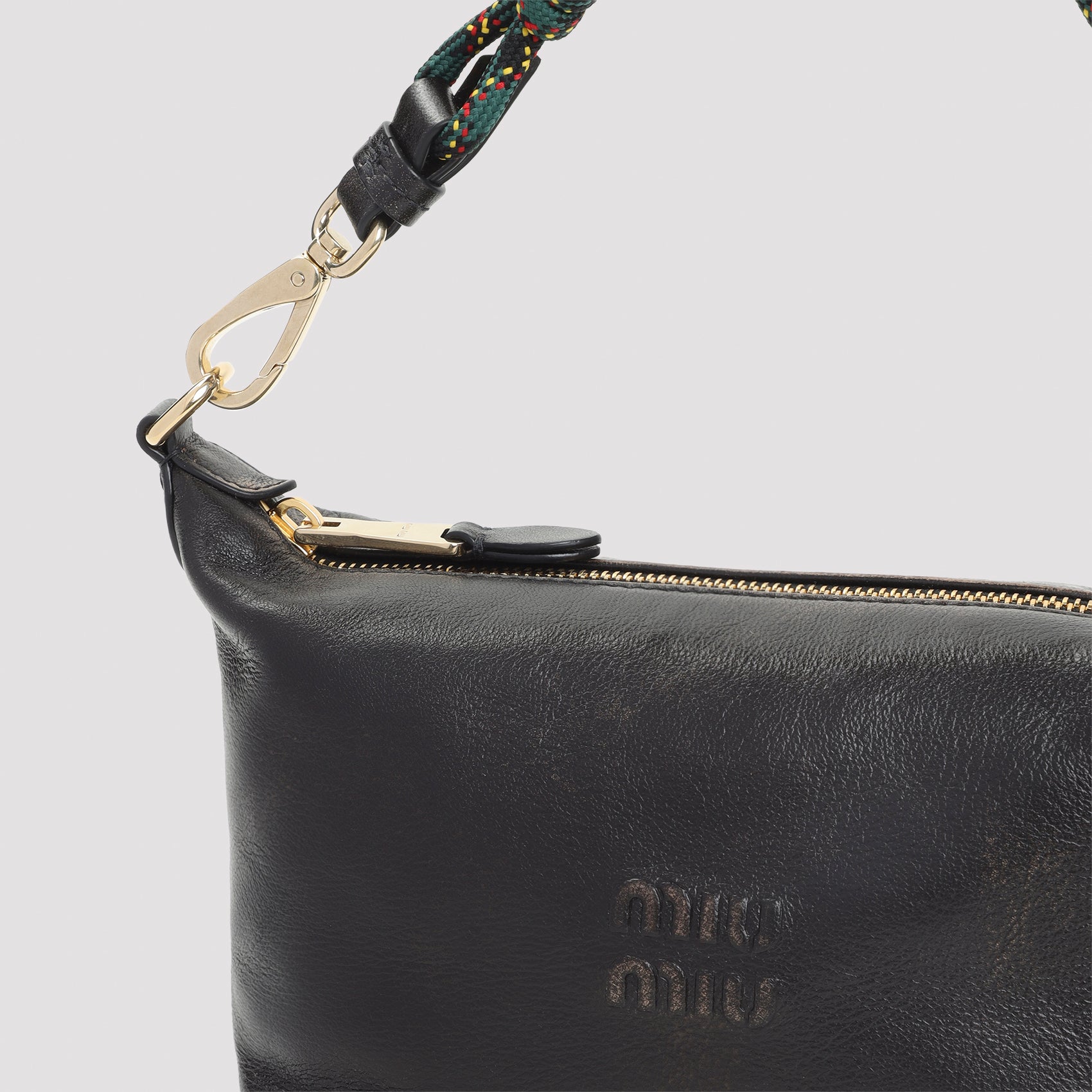 Brown Miu Miu leather pouch showing clasp fastening and zip closure