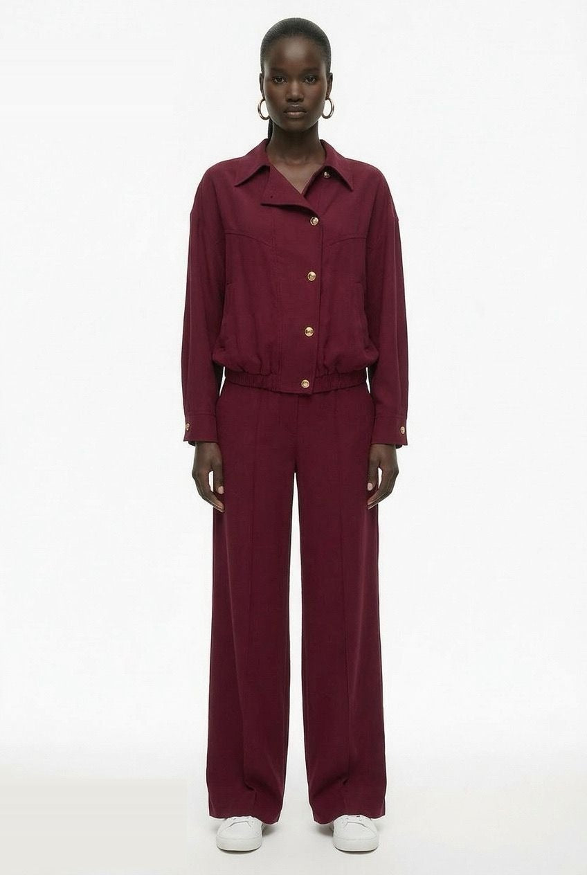 Burgundy collared bomber jacket styled with matching trousers, full outfit view