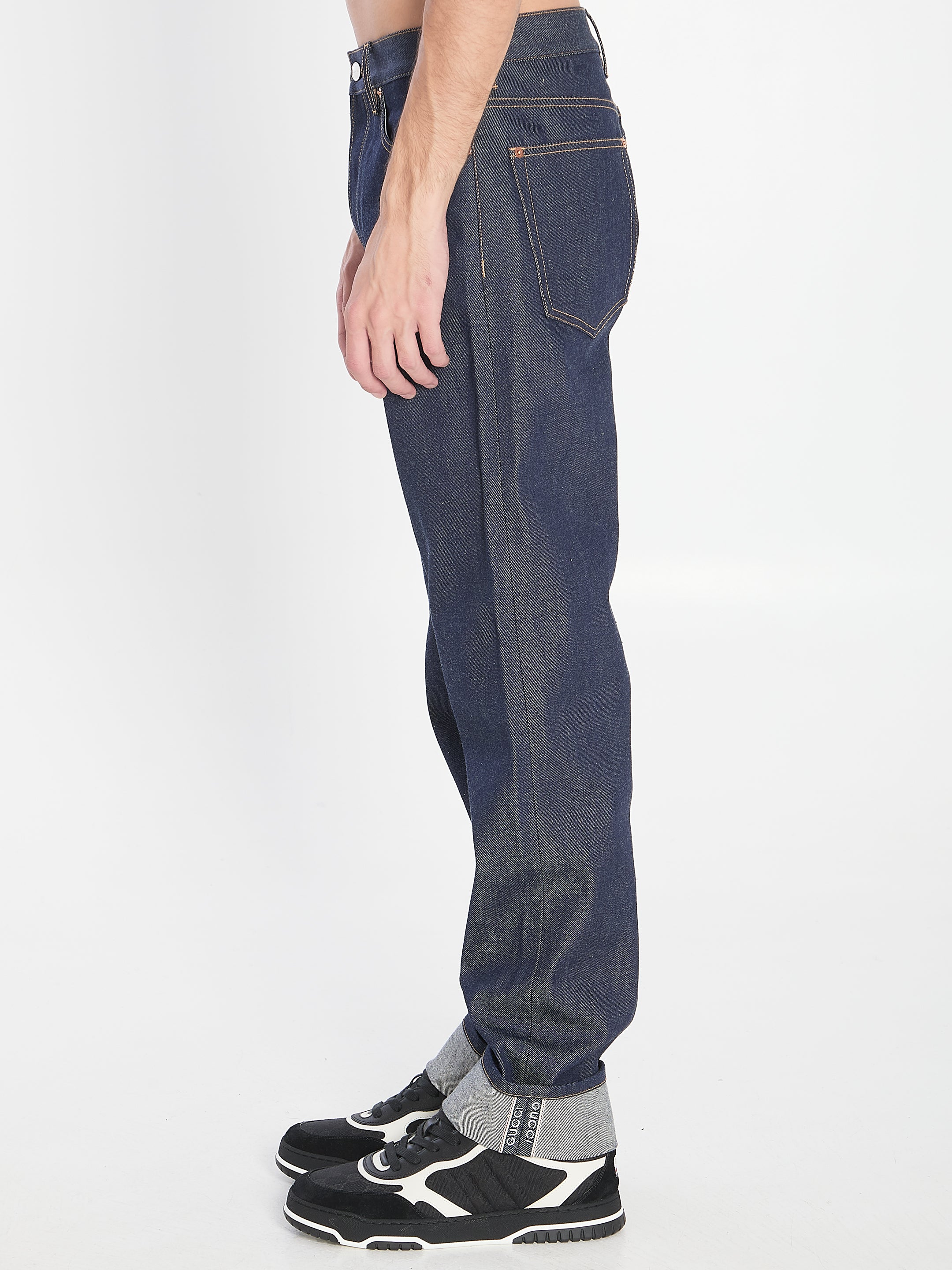 DENIM TROUSERS WITH HEM DETAILS Gucci