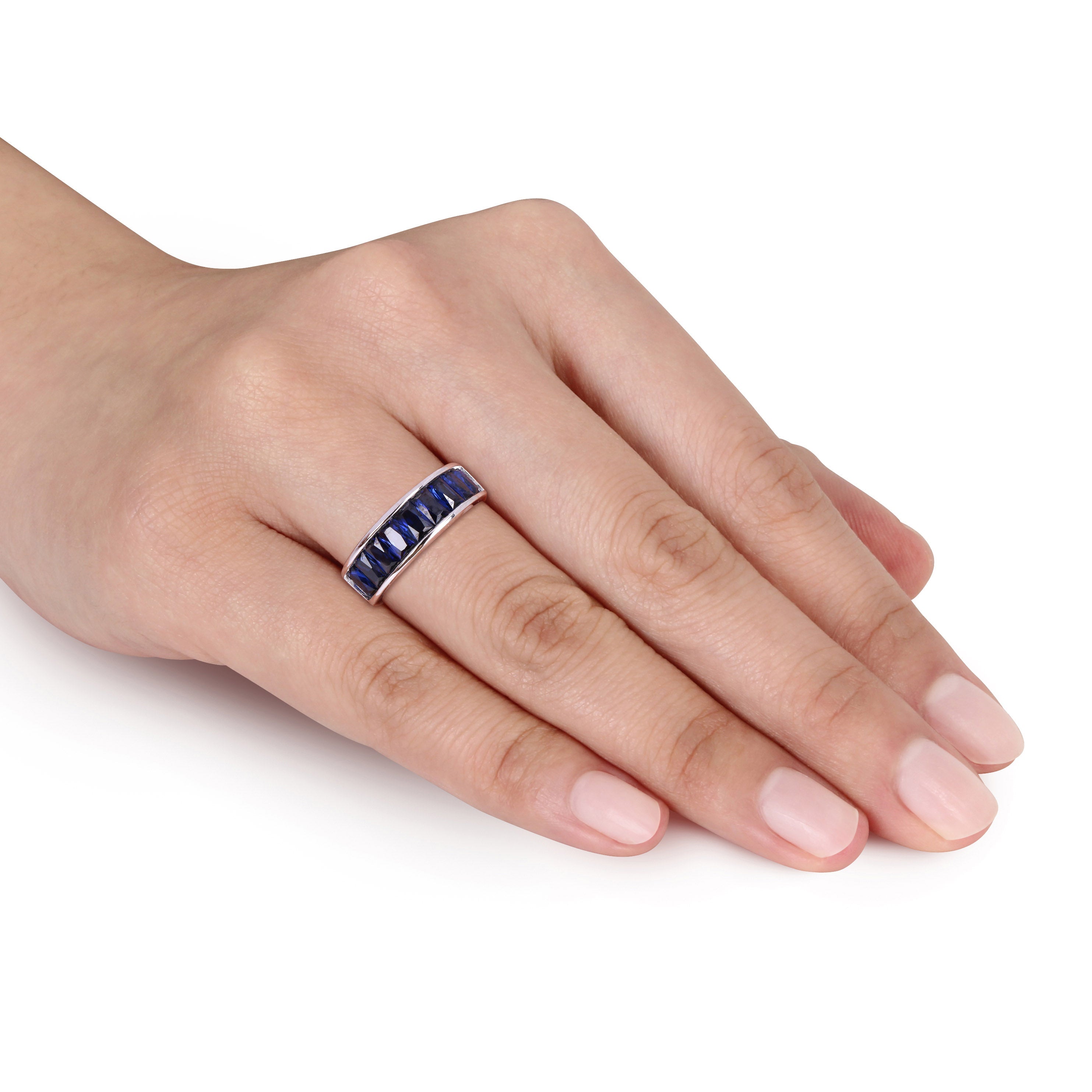 Blue sapphire anniversary ring on white background, detail view