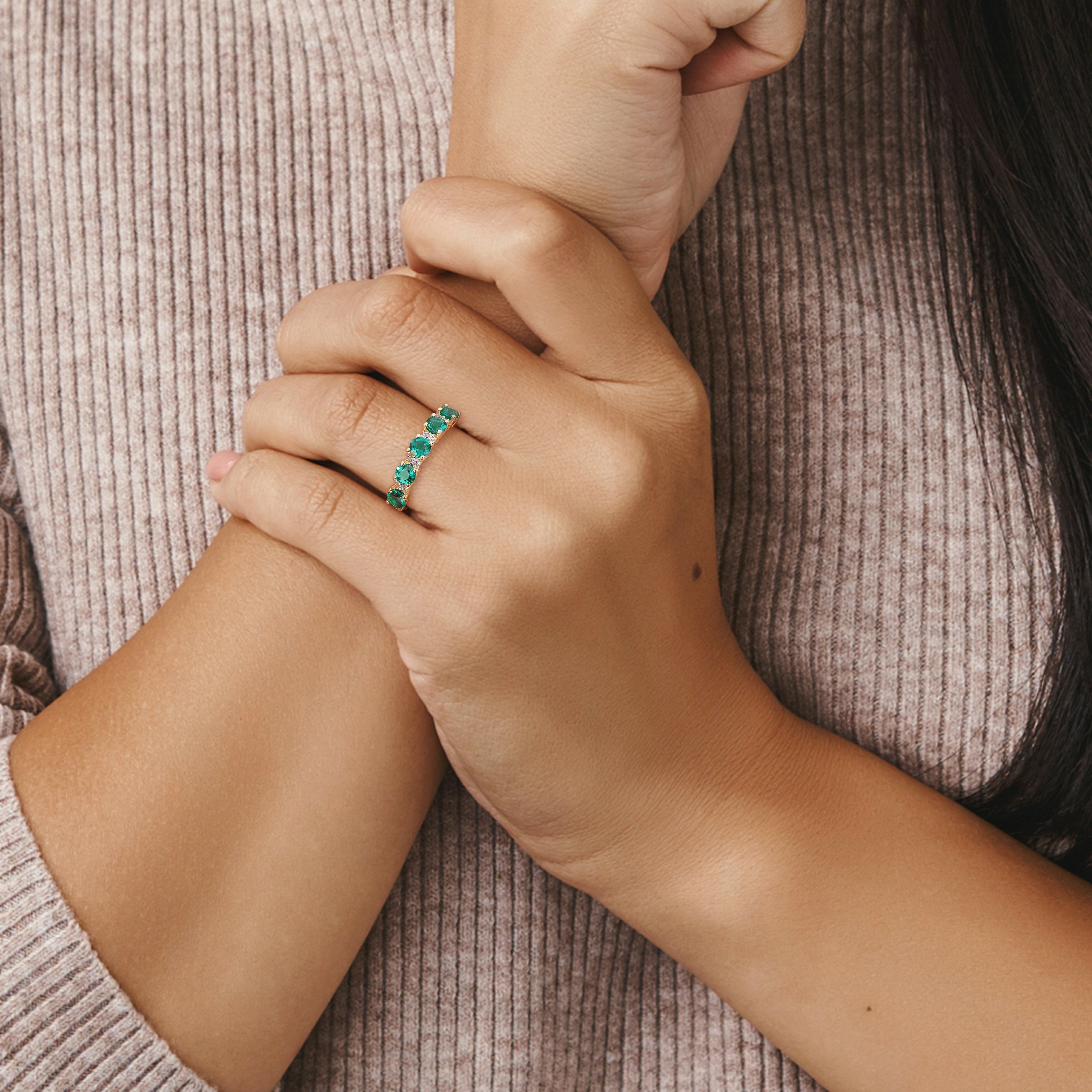 Created emerald semi-eternity ring in yellow-plated silver worn on hand by Lord & Taylor