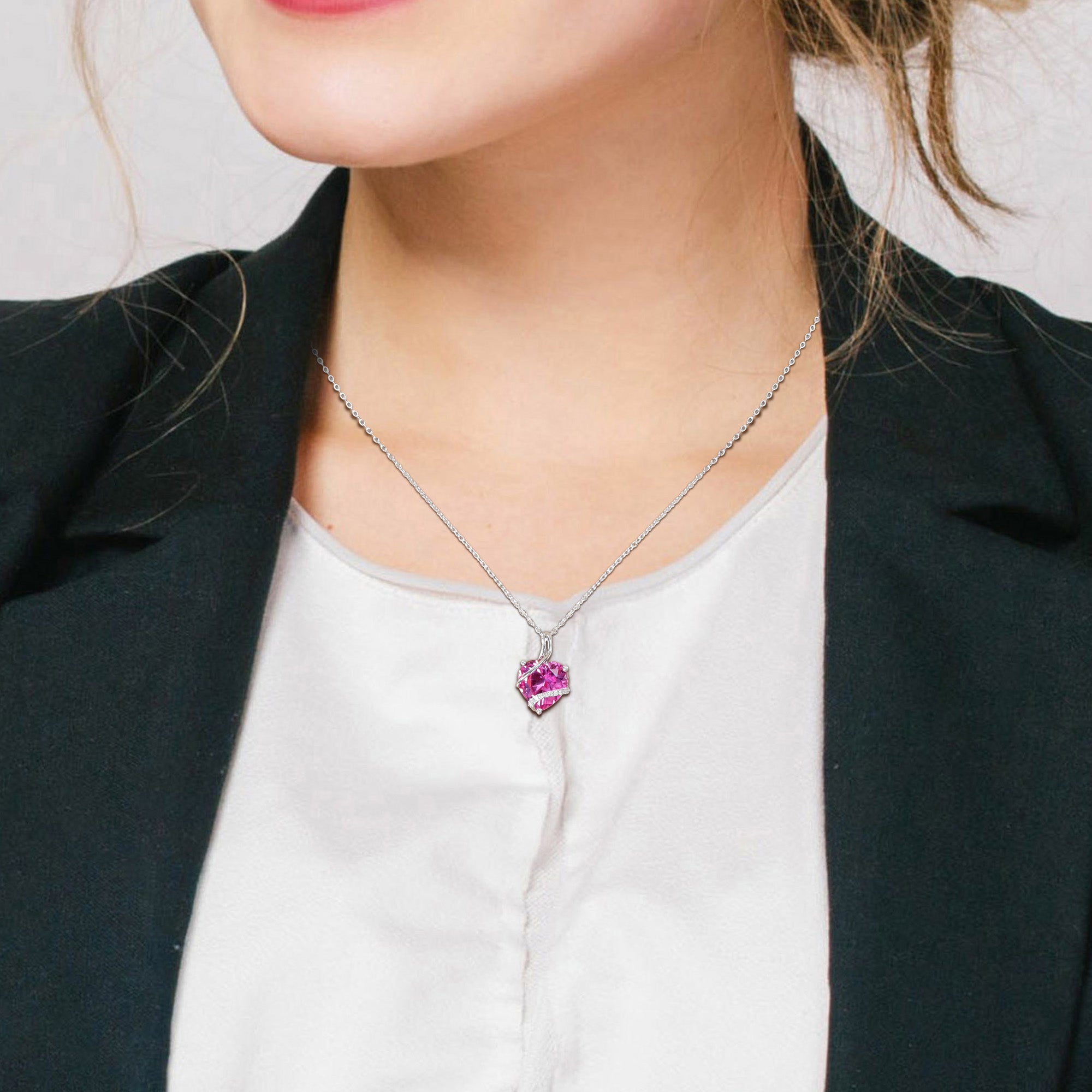 Pink sapphire heart pendant necklace by Delmar, worn on model