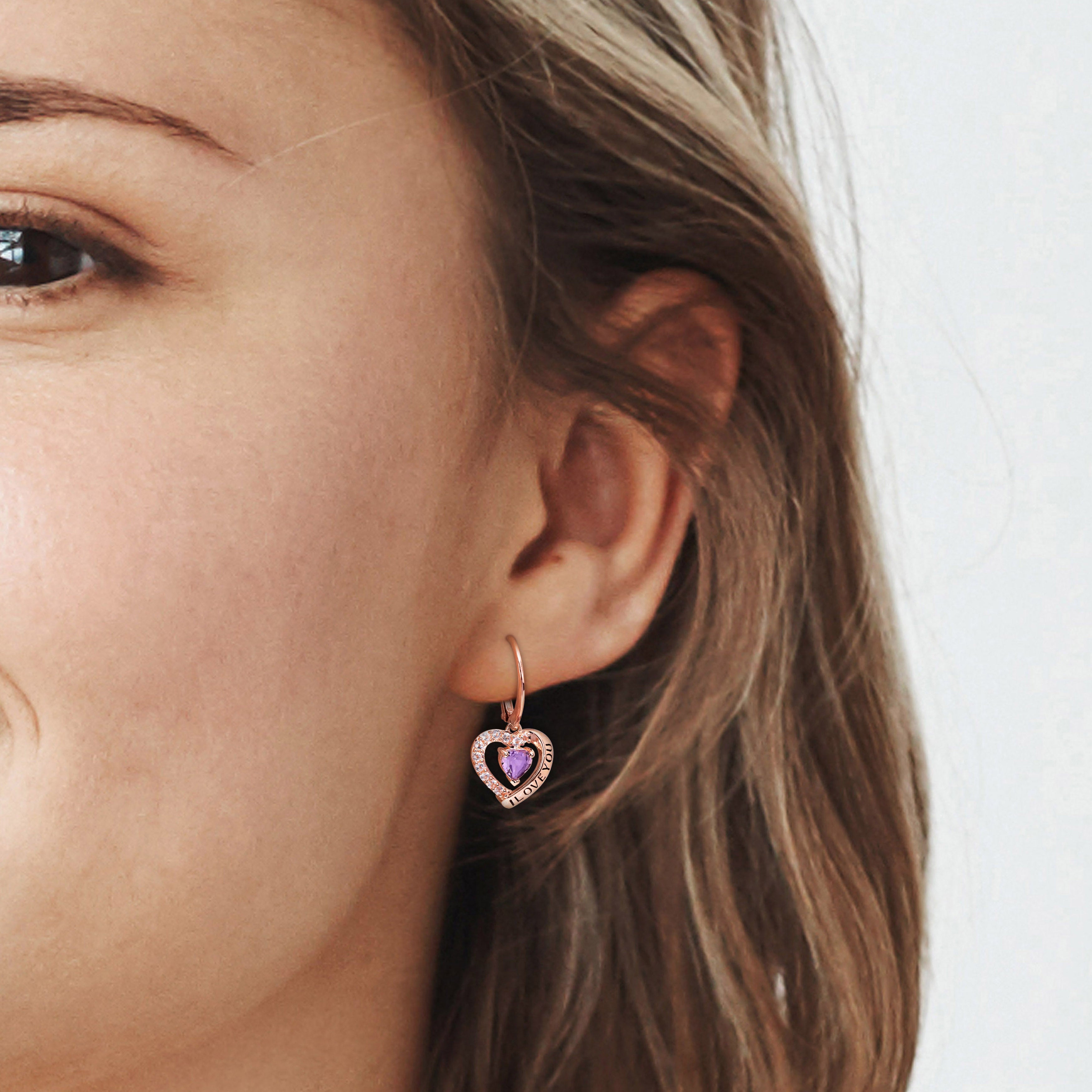 Rose gold plated amethyst heart earrings worn, showing dangle length and high polish finish