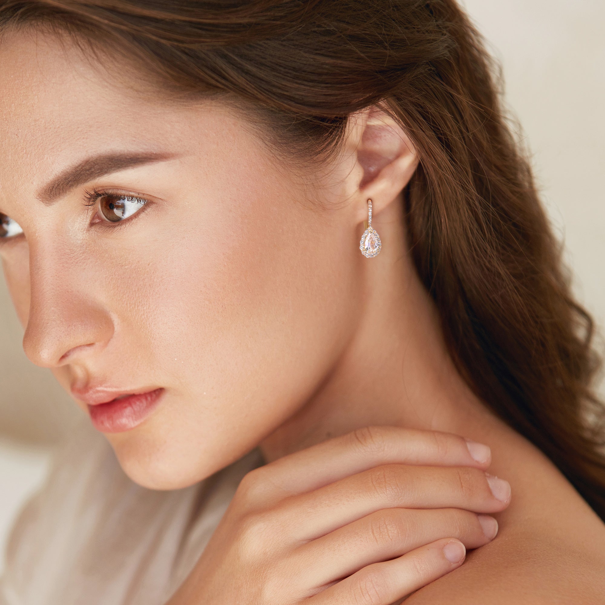 Yellow gold plated teardrop halo earrings worn, lifestyle view