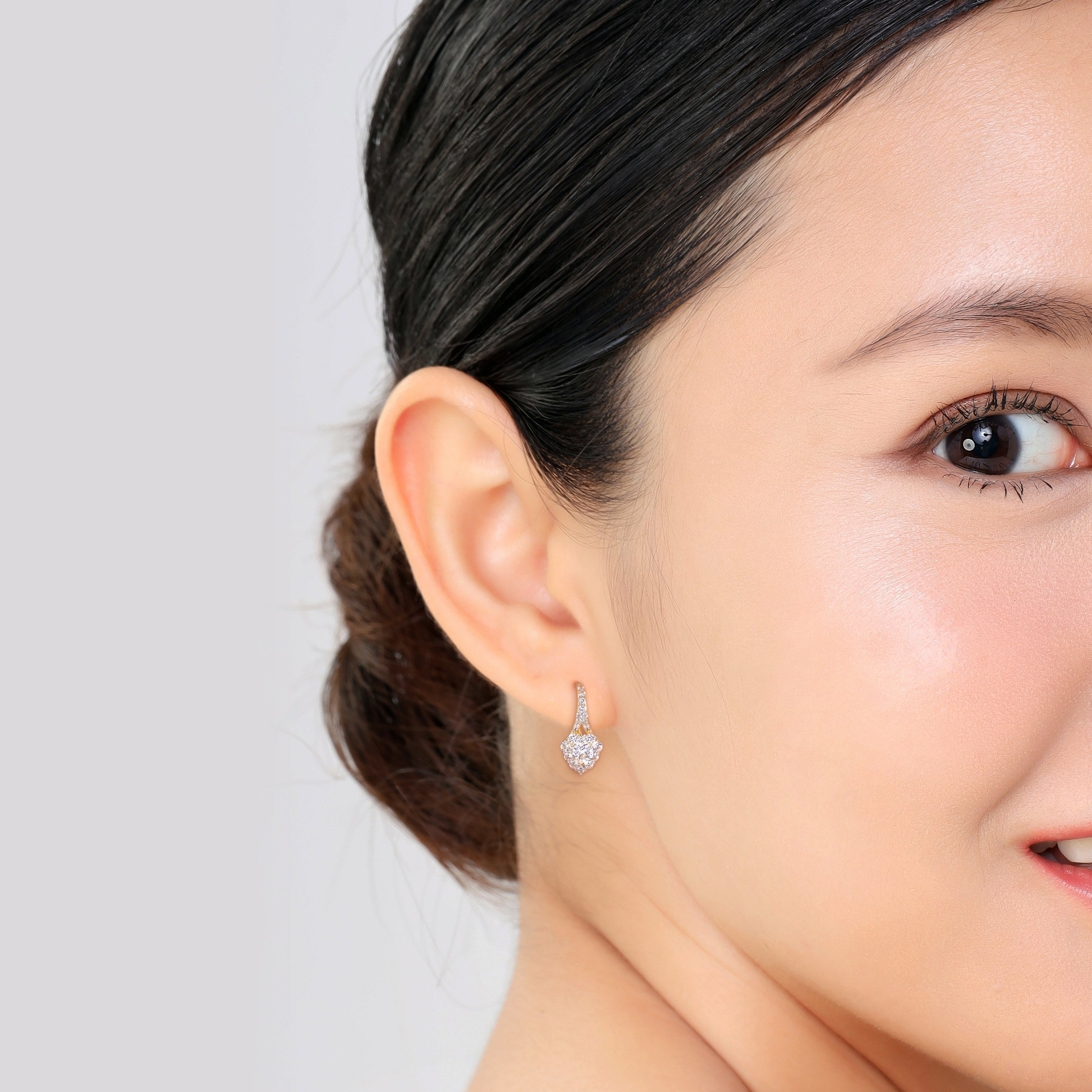 Yellow-plated silver heart earrings with sapphire halo worn, lifestyle view