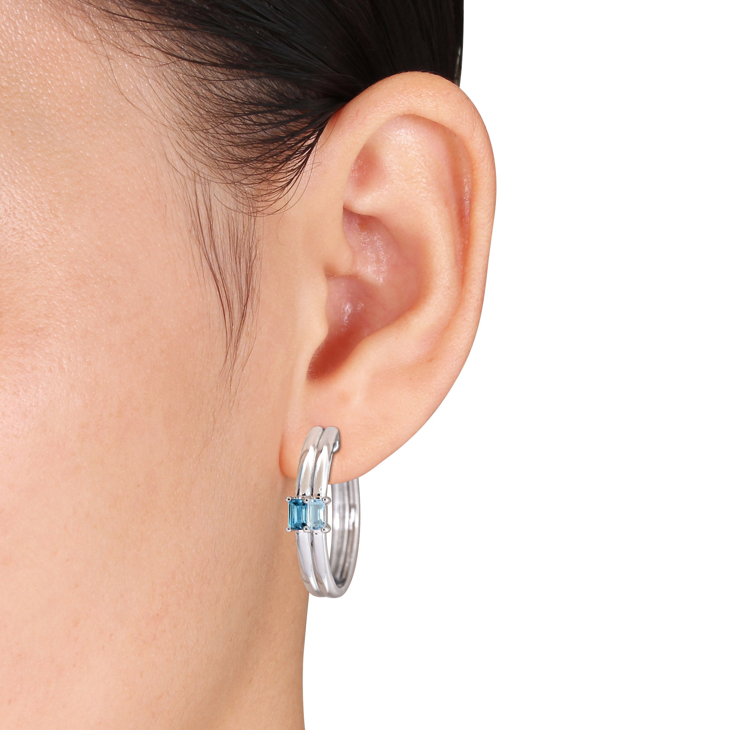 Sterling silver hoop earrings with emerald-cut blue topaz, side angle