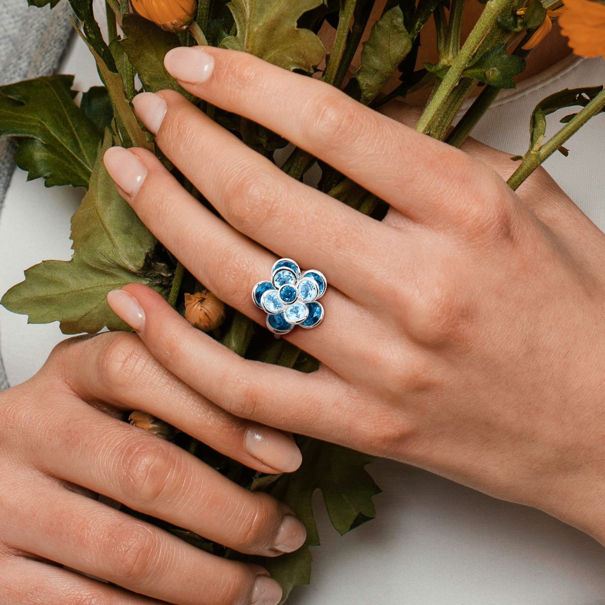 Blue topaz flower ring worn on hand, lifestyle view