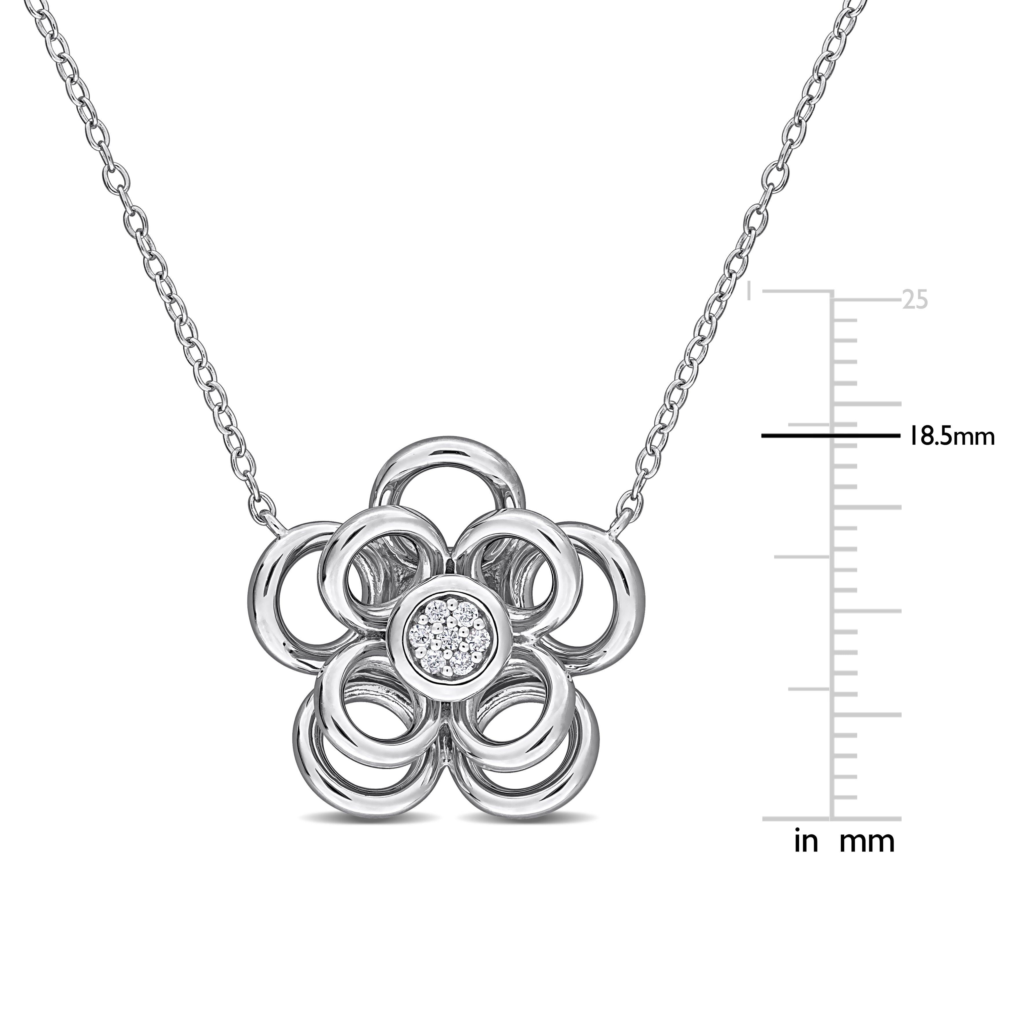 Close-up of diamond flower pendant showing round-cut stones and petals