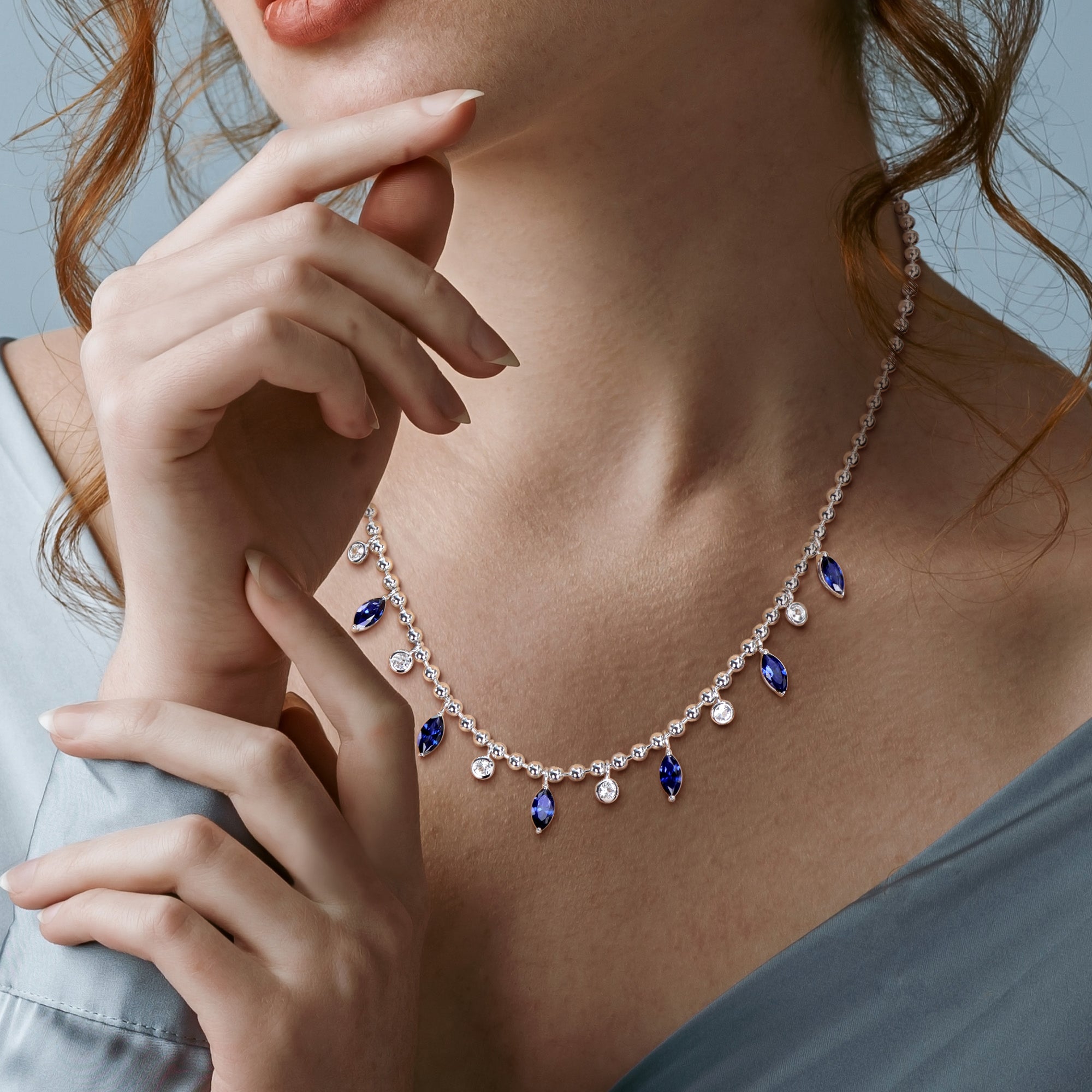 Sterling silver sapphire charm necklace by Lord & Taylor worn on model