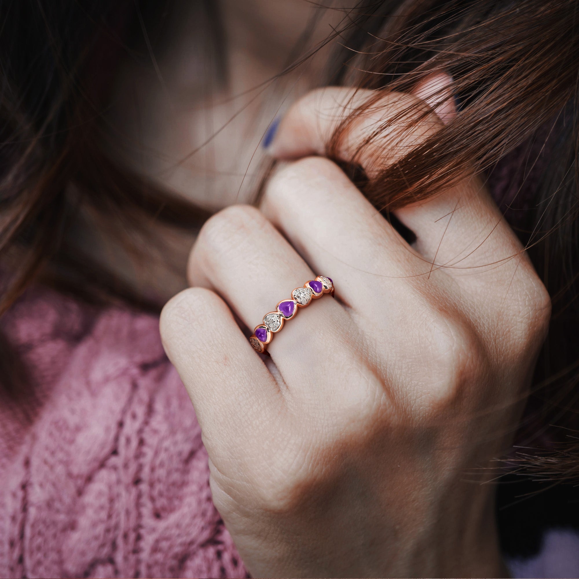 Rose gold plated heart eternity ring with amethyst stones worn on hand by Lord & Taylor