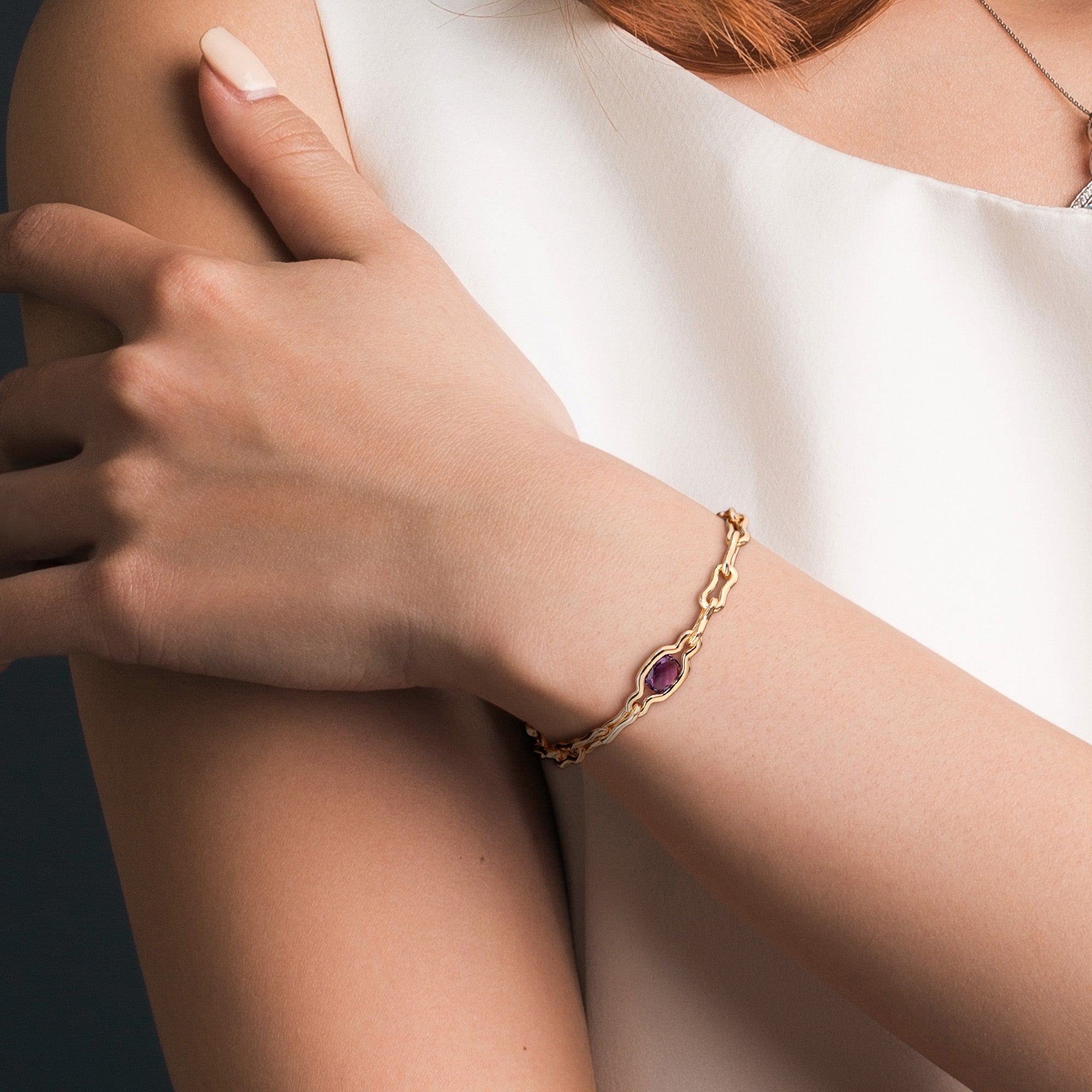 Yellow-plated sterling silver amethyst bracelet by Lord & Taylor worn on wrist, lifestyle view