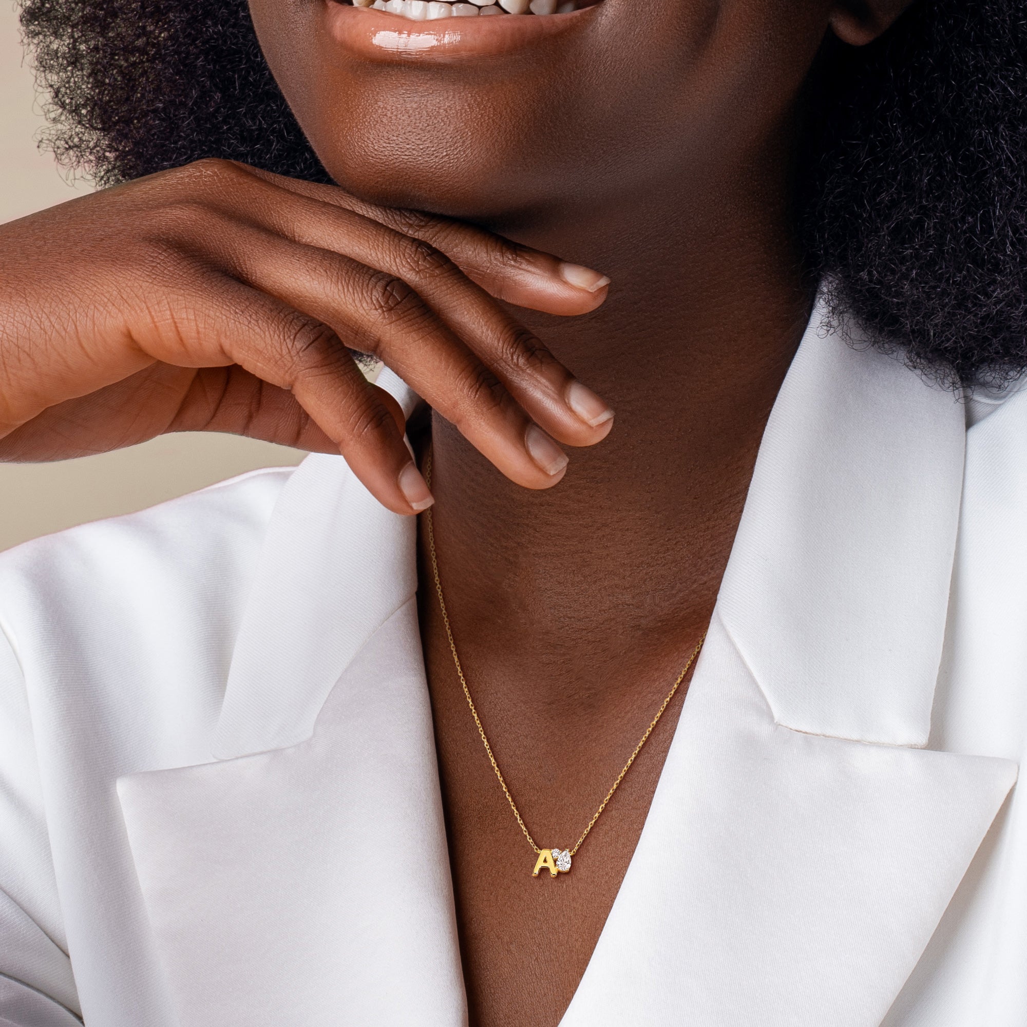 Yellow-plated initial pendant necklace lifestyle view worn with casual attire by Lord & Taylor