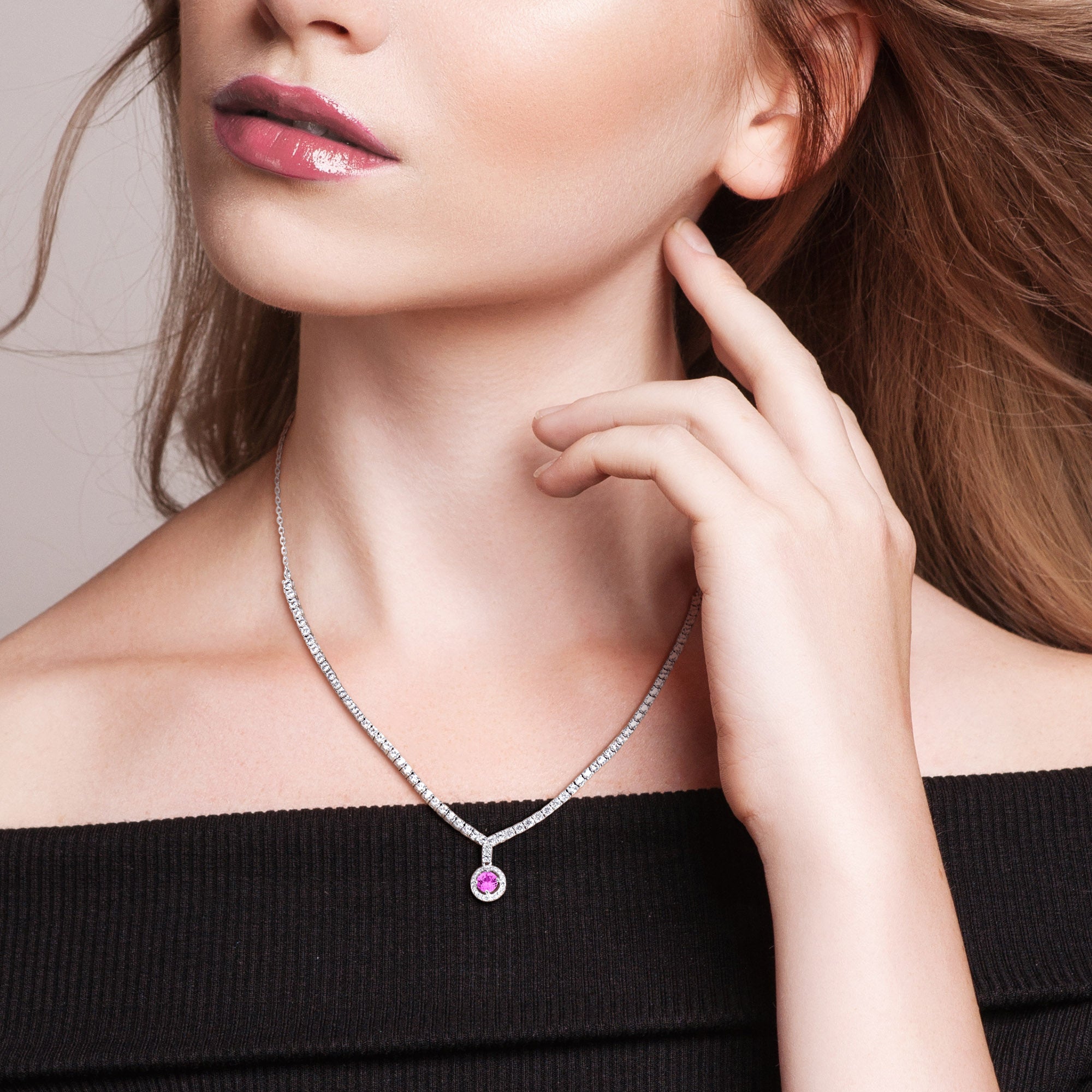 Pink sapphire halo tennis necklace worn on model, lifestyle view