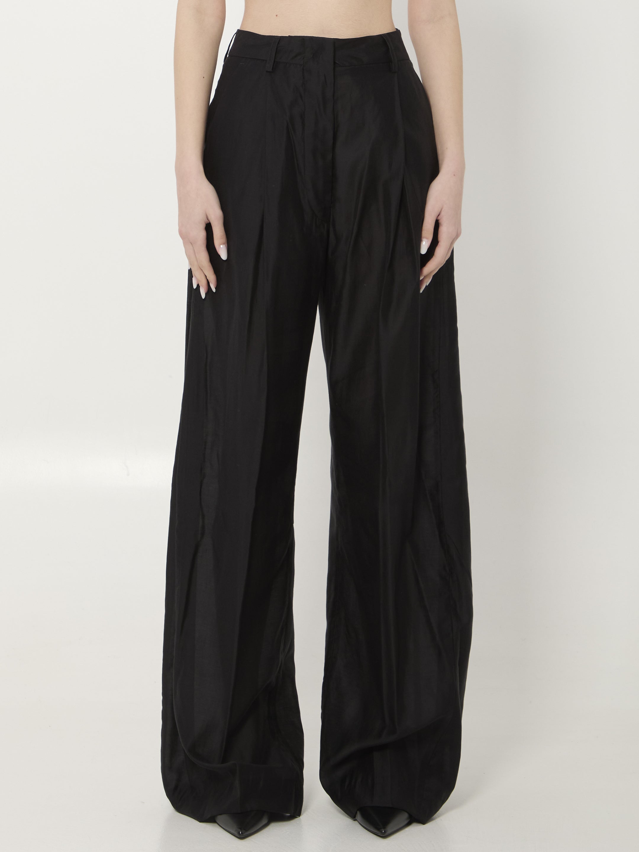 Black muslin wide leg trousers with high waist and pressed pleats by THE LATEST, front view