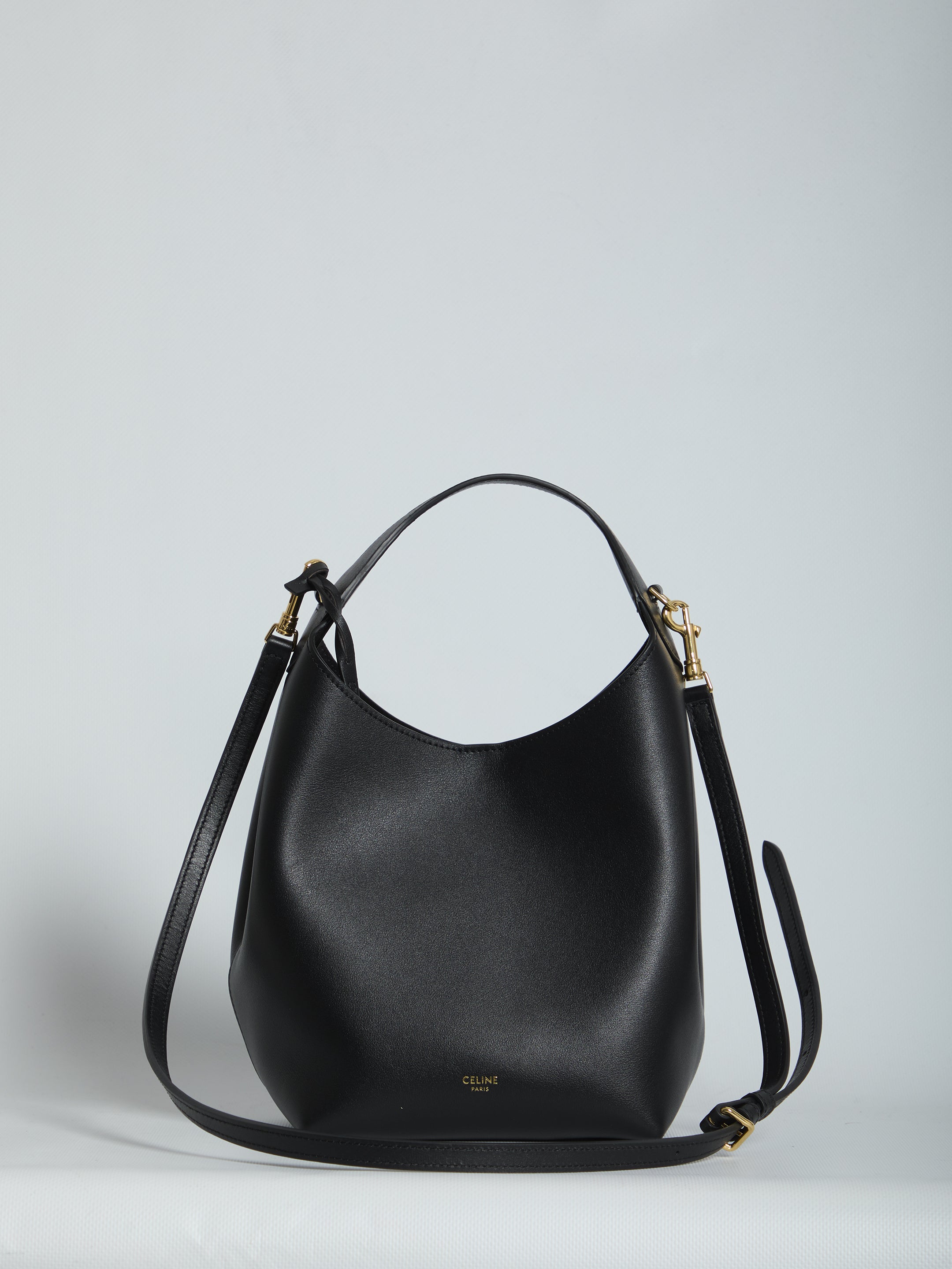 Black calfskin leather small hobo bag with top handle by Celine, front view