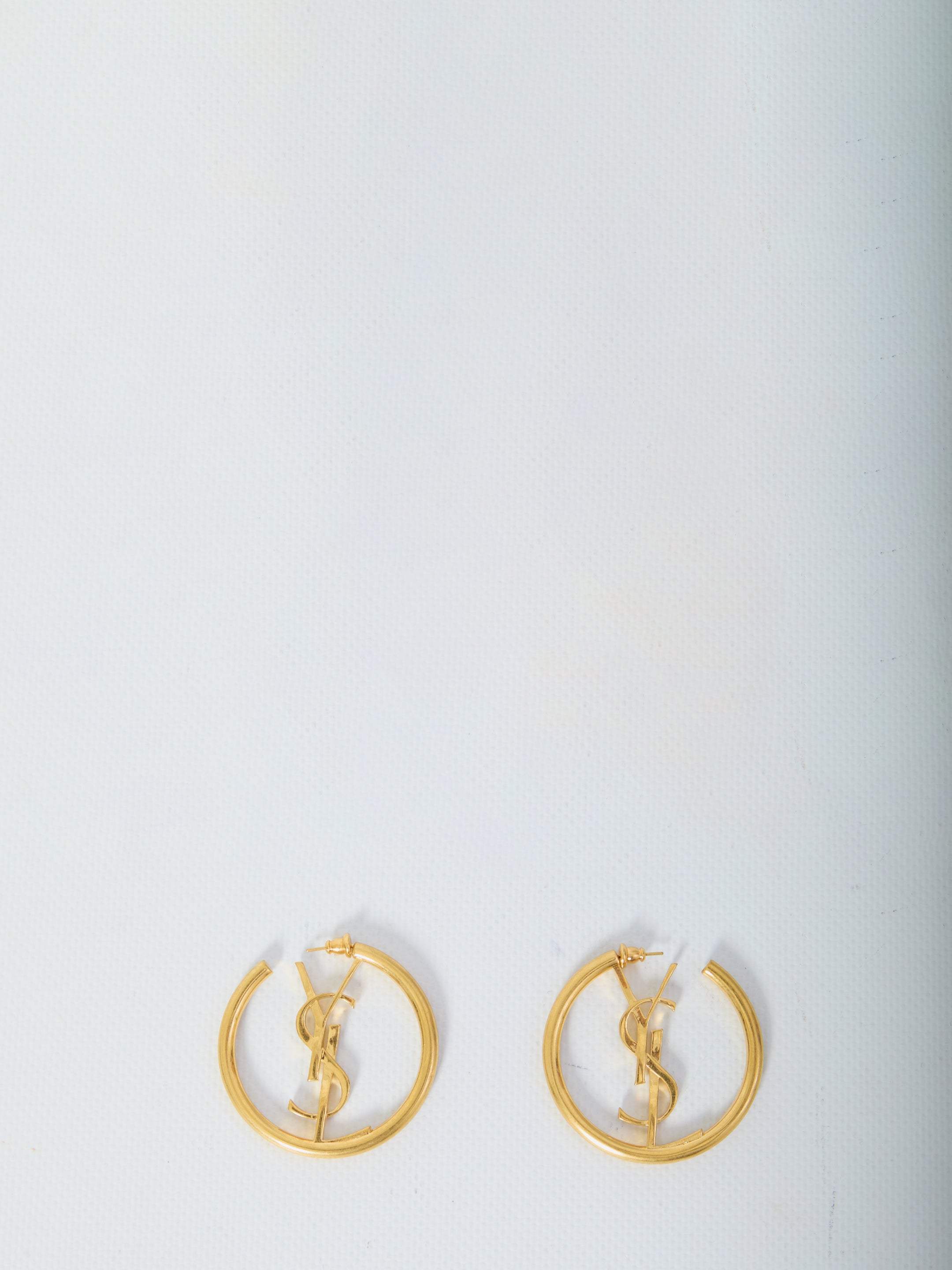 Gold-toned Saint Laurent Cassandre hoop earrings with inner decoration, front view