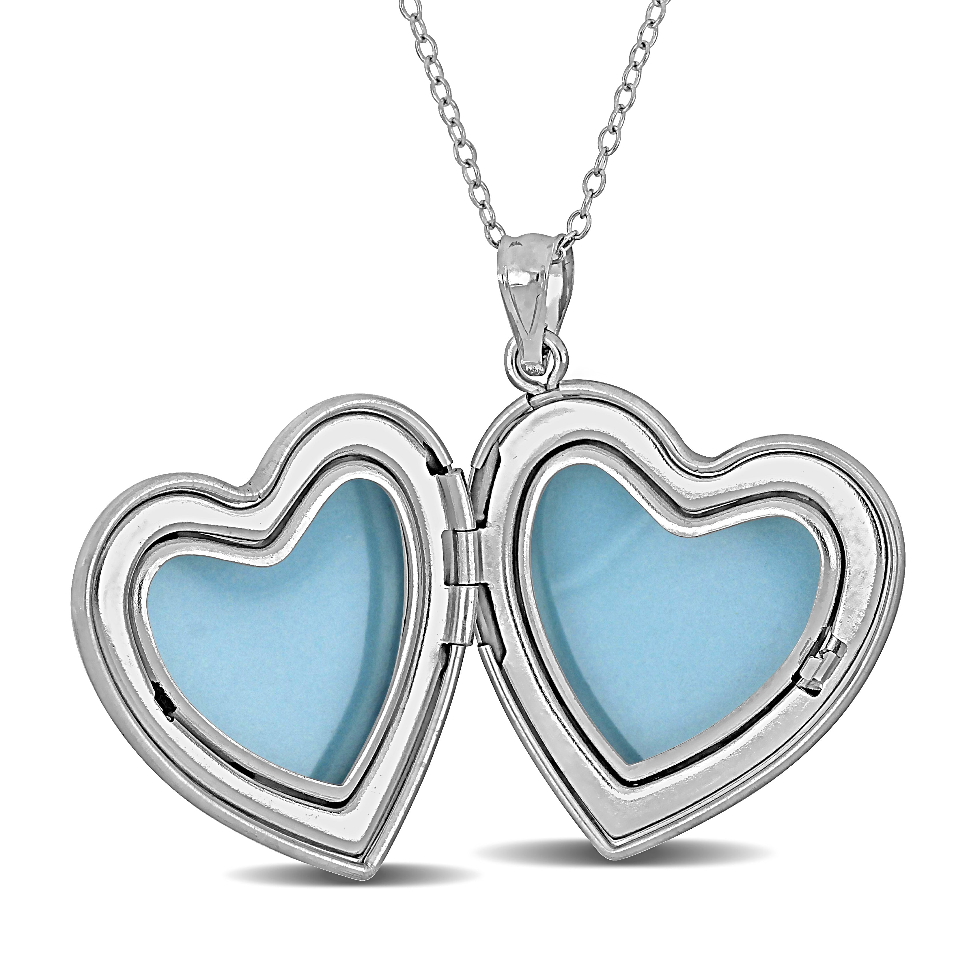 Sterling silver heart locket pendant open to show interior photo compartment, detail view