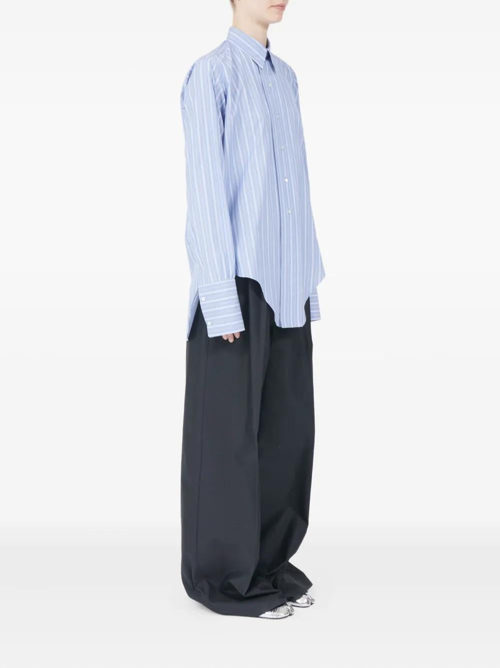 Blue striped cotton shirt by Maison Margiela, side view with button closure