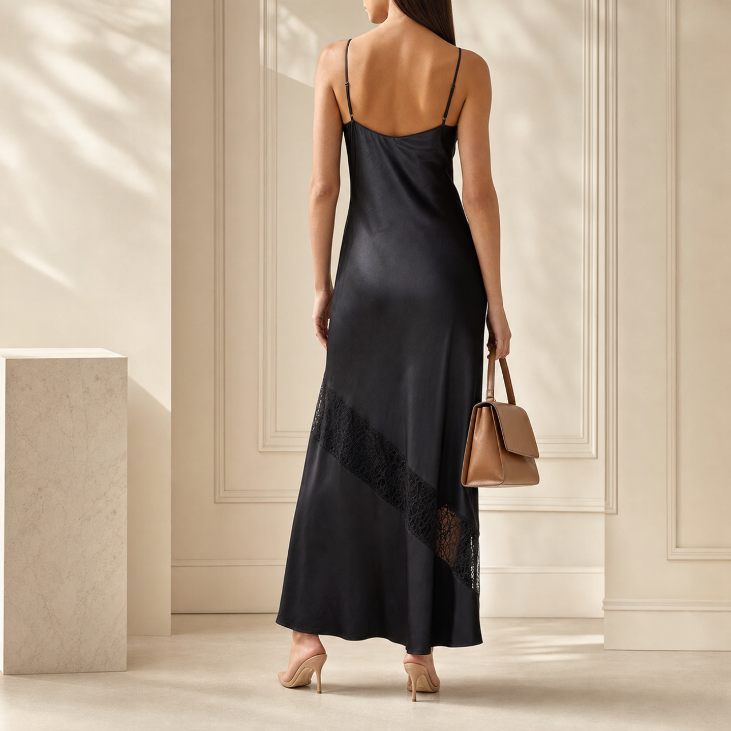 Black satin slip dress back view showing bias-cut construction