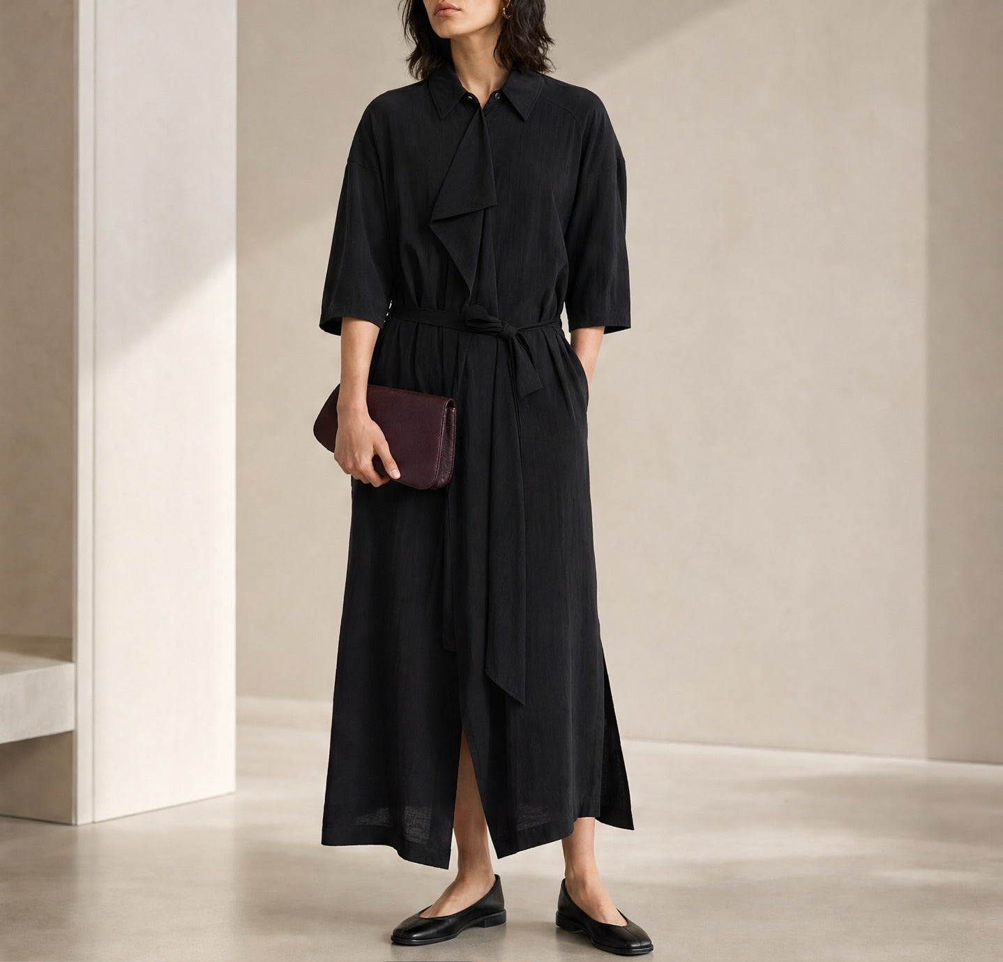 Black Lemaire asymmetrical midi dress with tie belt, full body front view