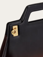Salvatore Ferragamo top handle bag showing architectural silhouette, overhead view