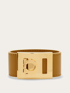 Tan leather cuff bracelet with gold-tone Gancini buckle by Salvatore Ferragamo, front view