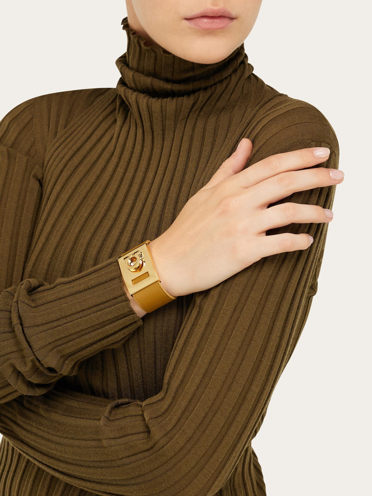 Tan leather wide cuff bracelet by Salvatore Ferragamo, side angle view
