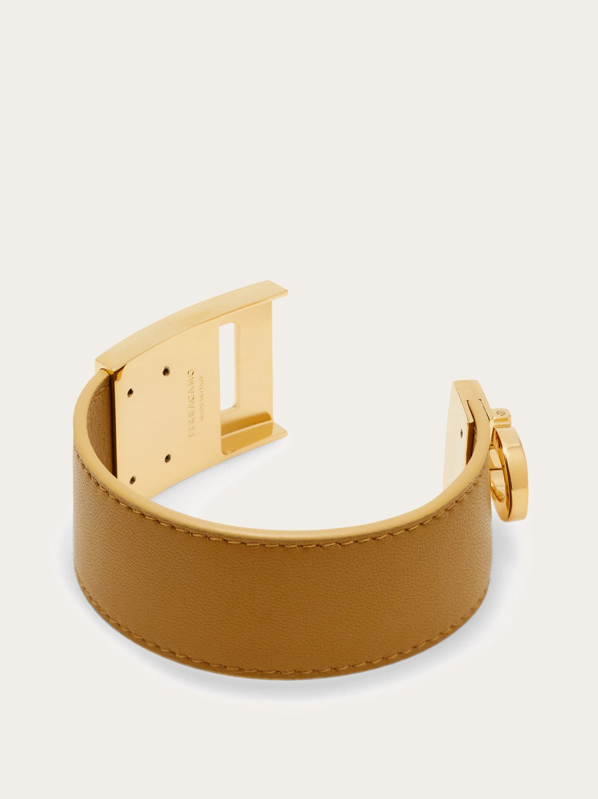 Salvatore Ferragamo leather cuff bracelet in tan showing buckle closure mechanism