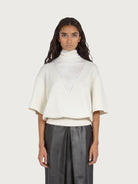White Salvatore Ferragamo knit top with high collar, side view