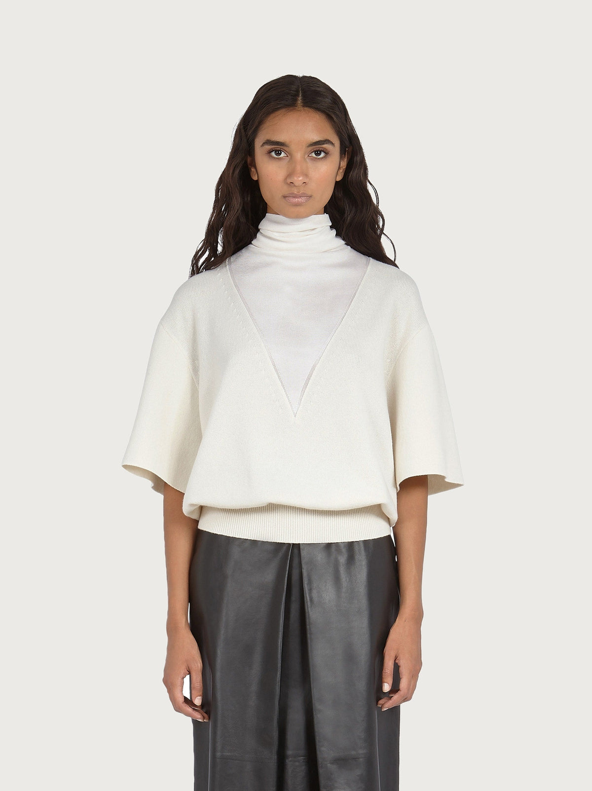 White Salvatore Ferragamo knit top with high collar, side view