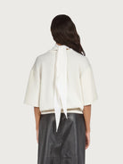 White Salvatore Ferragamo knit top showing sheer back panel detail
