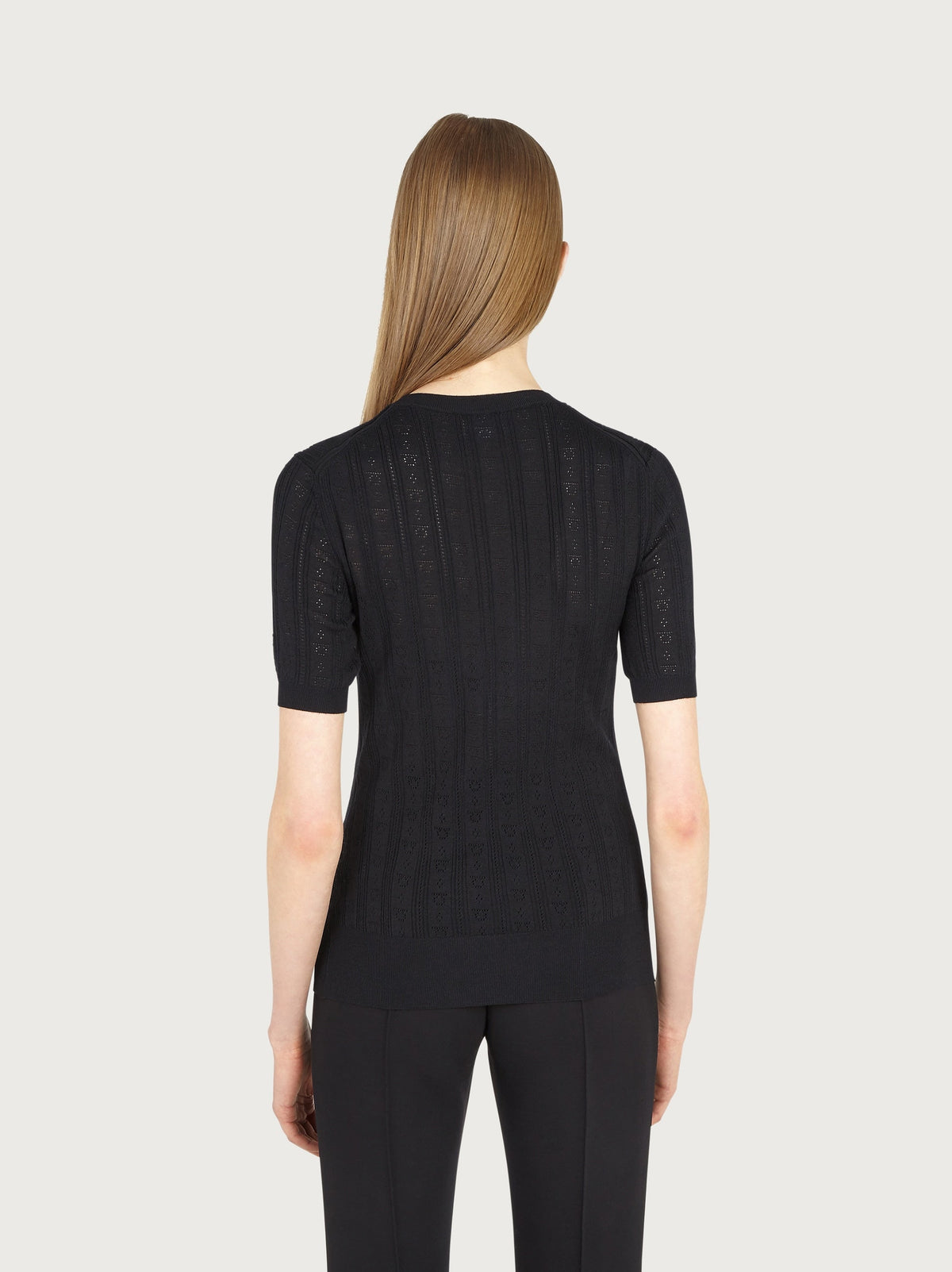 Close-up of Gancini motif openwork on black wool knit by Salvatore Ferragamo
