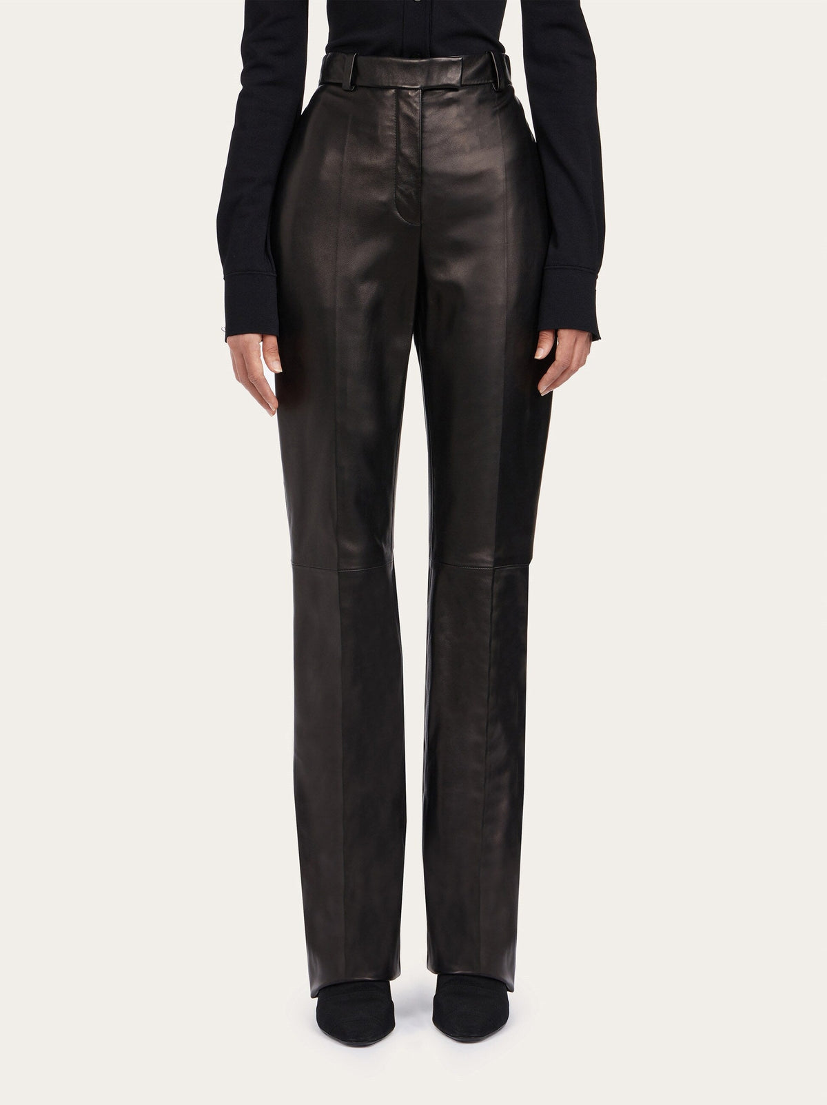 Black Salvatore Ferragamo leather trousers, side view showing straight-leg cut