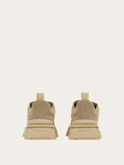 Salvatore Ferragamo beige sneaker showing branded heel counter and pull-tab, rear view