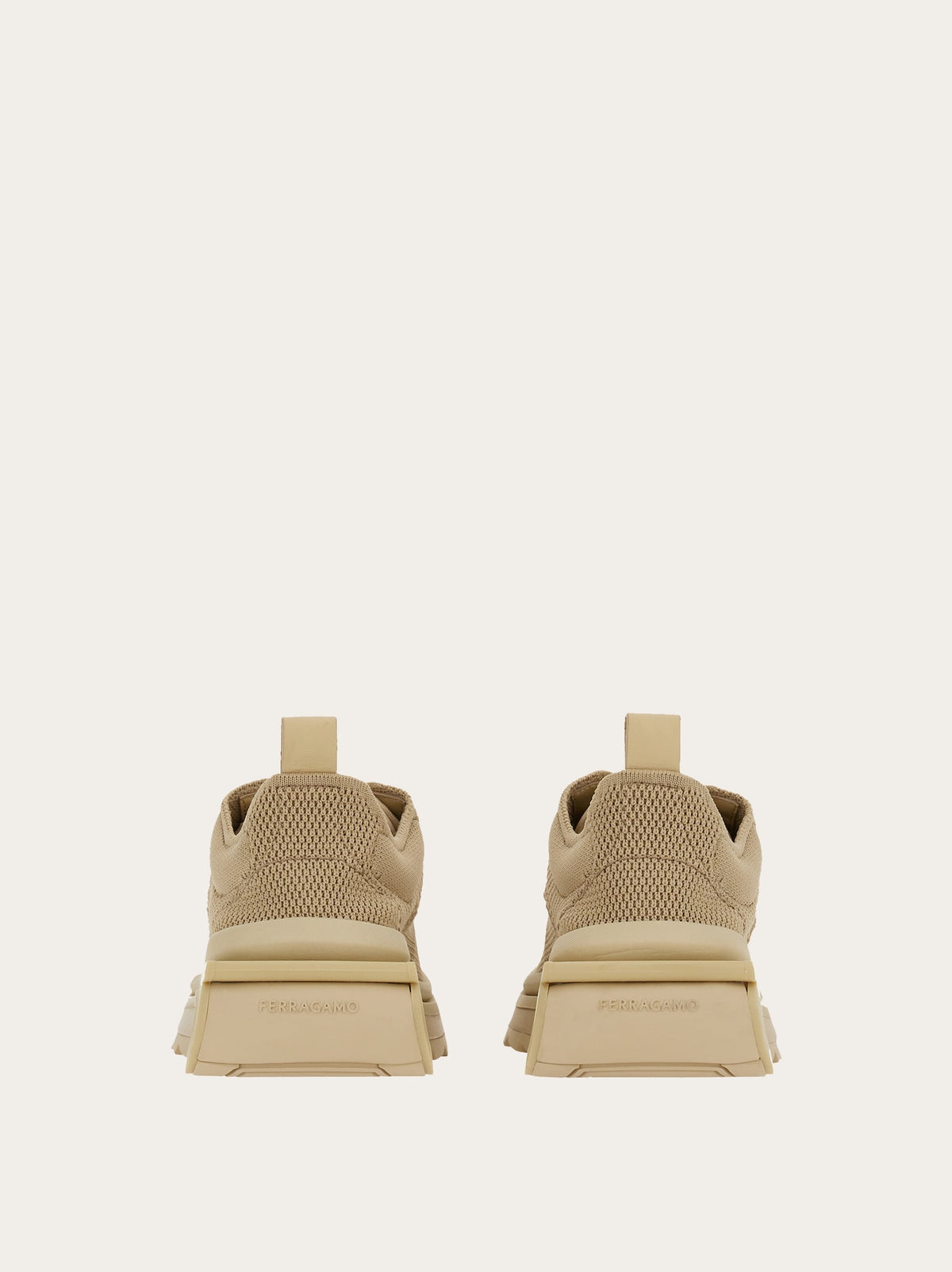 Salvatore Ferragamo beige sneaker showing branded heel counter and pull-tab, rear view