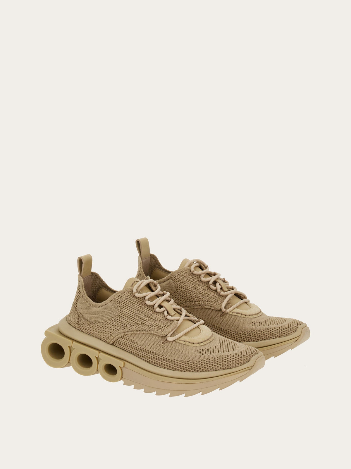 Beige knit sneaker by Salvatore Ferragamo with rubber sole, bottom view