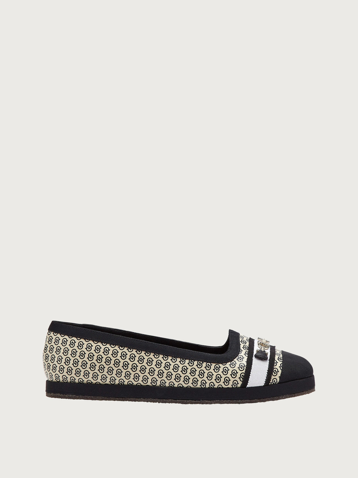 Cream jacquard ballet flat with black cap toe by Salvatore Ferragamo, side view