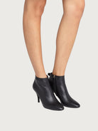 Black Salvatore Ferragamo ankle bootie showing stiletto heel and sole