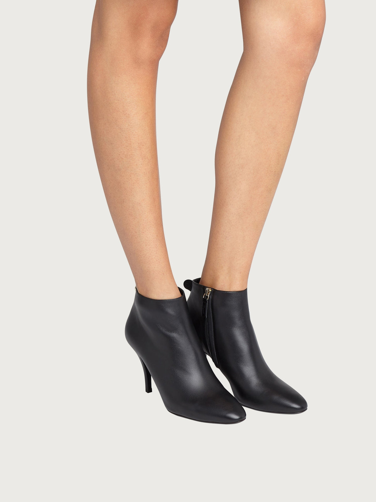 Black Salvatore Ferragamo ankle bootie showing stiletto heel and sole