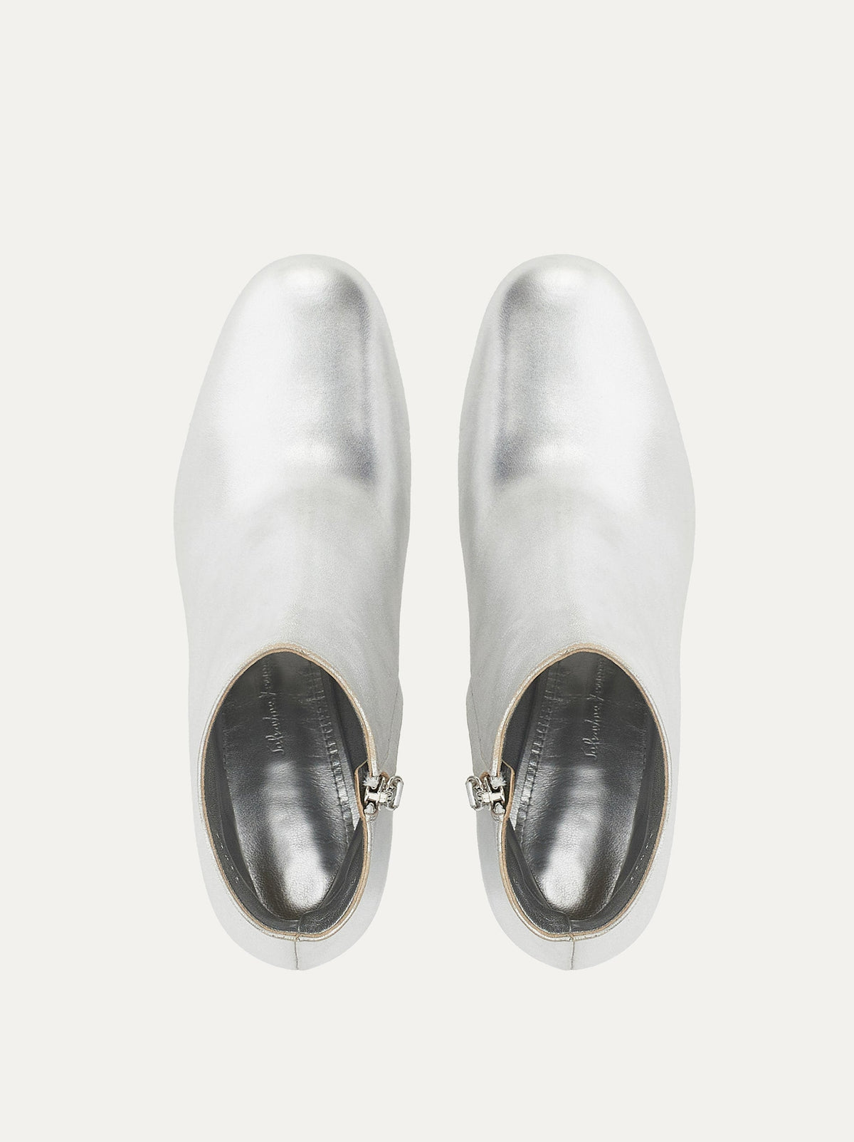 Salvatore Ferragamo silver bootie showing side zipper closure, angled view