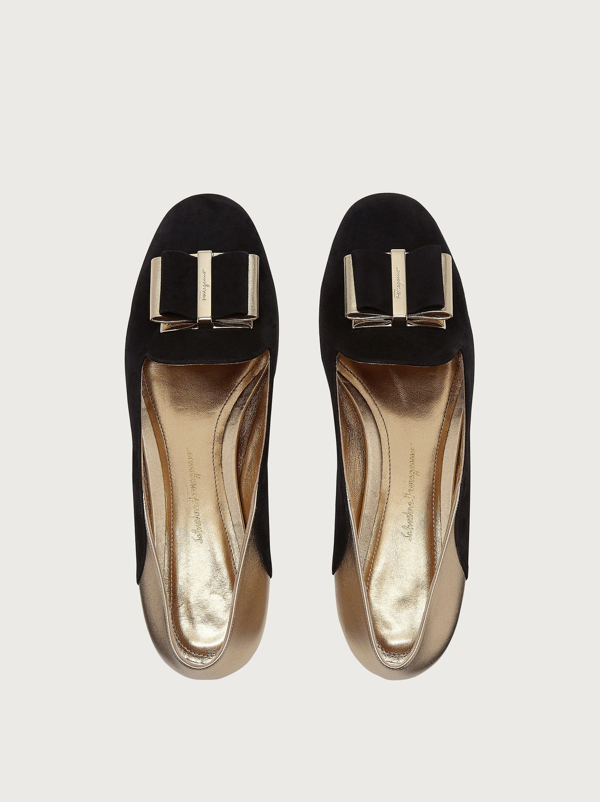 Black suede ballet flat by Salvatore Ferragamo, top view with bow hardware