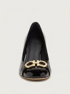 Black patent leather Garda pump with gold-tone Gancini ornament by Salvatore Ferragamo, side view