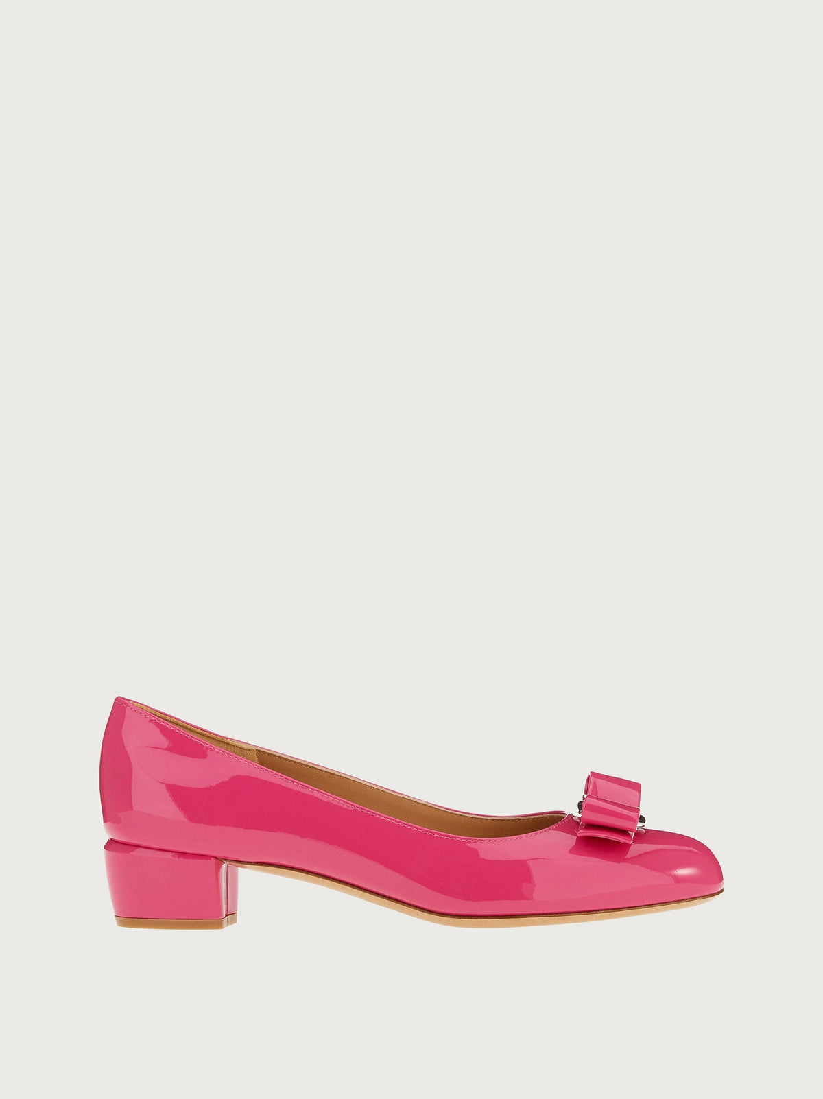 Dark pink patent leather Vara bow pump by Salvatore Ferragamo, side view