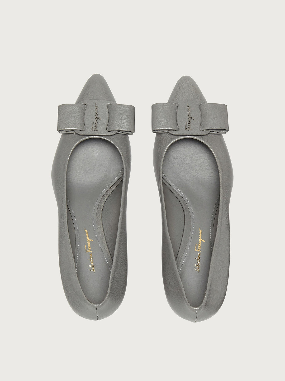 Light grey pointed-toe pump with block heel by Salvatore Ferragamo, rear view